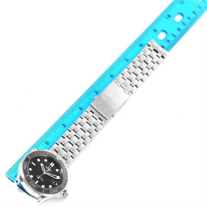 The Omega Speedmaster 212.30.41.20.01.005 Men
s Stainless Steel Black Dial 212.30.41.20.01.005 Men
s Stainless Steel Black Dial watch is shown from a top-down angle, displaying its face, bezel, and metal bracelet next to a ruler.