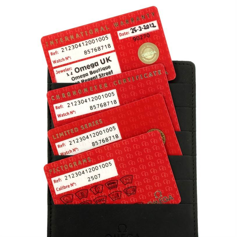 The image shows the warranty cards and certificates for the Omega Speedmaster 212.30.41.20.01.005 Men
s Stainless Steel Black Dial 212.30.41.20.01.005 Men
s Stainless Steel Black Dial watch, displayed in a black holder.