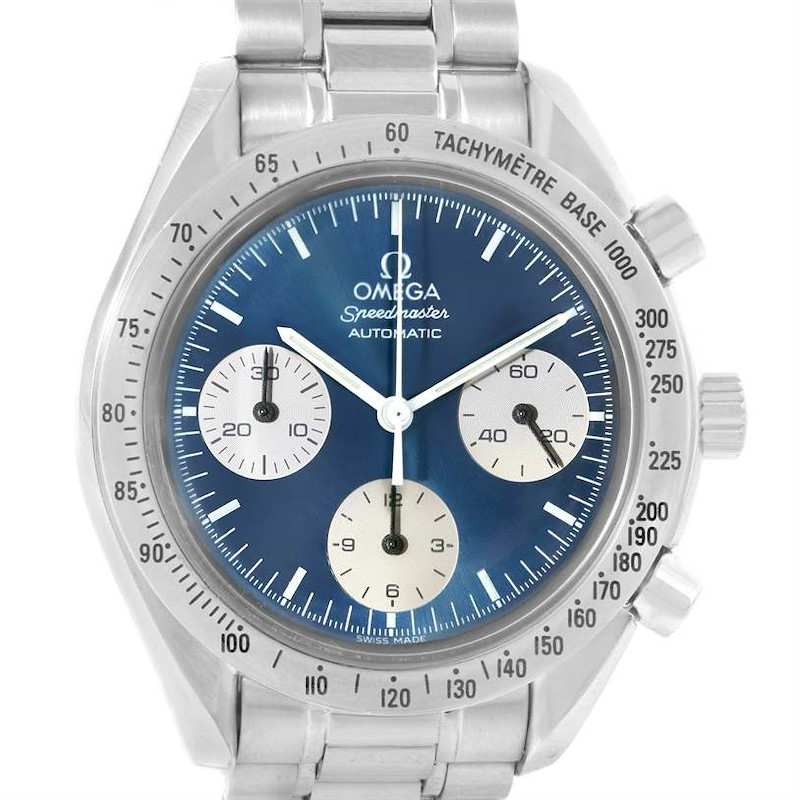 The image shows a front view of the Omega Speedmaster watch, highlighting the dial, chronograph subdials, and tachymeter scale.