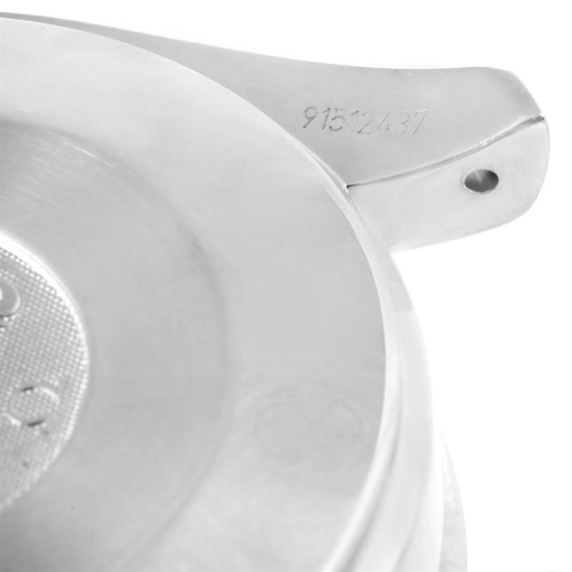 This close-up image of an Omega Speedmaster 3539.50.00 Men
s Stainless Steel Black Dial 3539.50.00 Men
s Stainless Steel Black Dial watch shows the back case with engraved serial numbers and part of the lugs.