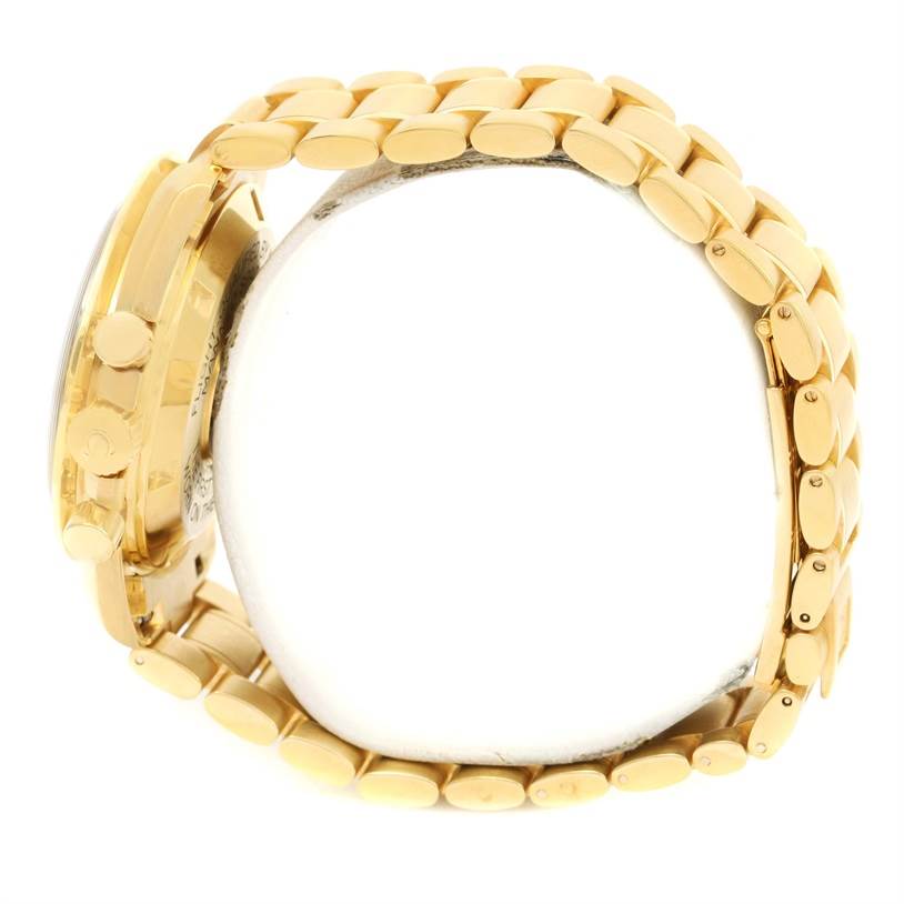 The image shows a side view of the Omega Speedmaster 3195.50.00 Men's Yellow Gold Black Dial 3195.50.00 Men's Yellow Gold Black Dial watch, highlighting the gold bracelet and side controls.