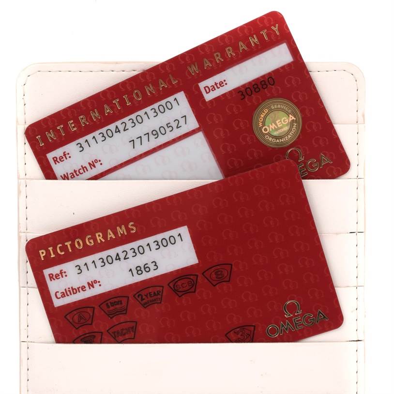 The image shows the international warranty and pictograms cards for the Omega Speedmaster 311.30.42.30.13.001 Men's Stainless Steel Brown Dial 311.30.42.30.13.001 Men's Stainless Steel Brown Dial watch.