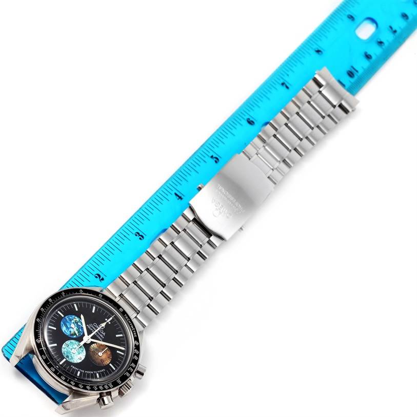 The Omega Speedmaster 3577.50.00 Men
s Stainless Steel Black Dial 3577.50.00 Men
s Stainless Steel Black Dial watch is shown lying flat with its stainless steel bracelet and clasp extended beside a ruler.