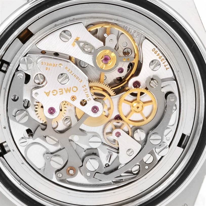 The image shows the intricate movement mechanics of an Omega Speedmaster 3577.50.00 Men
s Stainless Steel Black Dial 3577.50.00 Men
s Stainless Steel Black Dial watch from a back or case-back angle.