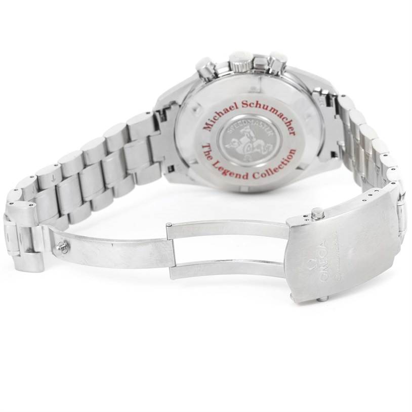 The image shows the back and bracelet of an Omega Speedmaster 3506.61.00 Men's Stainless Steel Red Dial 3506.61.00 Men's Stainless Steel Red Dial watch, featuring the "The Legend Collection" Michael Schumacher edition.