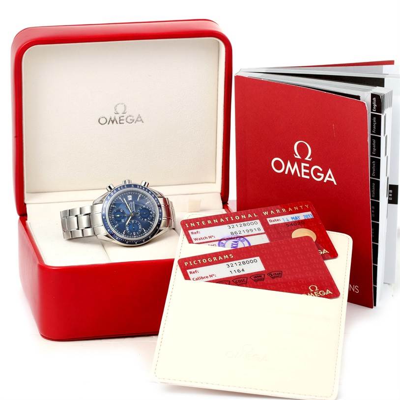 The Omega Speedmaster 3212.80.00 Men
s Stainless Steel Blue Dial 3212.80.00 Men
s Stainless Steel Blue Dial watch is displayed in an open red box, with warranty cards and a manual beside it.