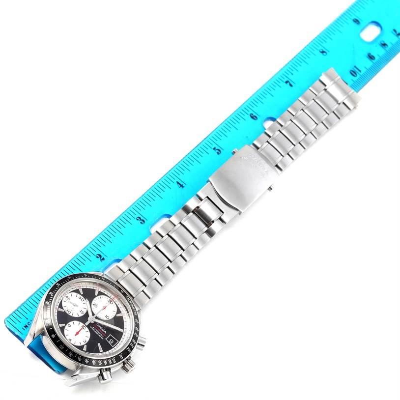 The image shows an Omega Speedmaster 81613043 Men
s Stainless Steel Black Dial 81613043 Men
s Stainless Steel Black Dial watch laid flat next to a ruler, highlighting its face, case, and metal bracelet.