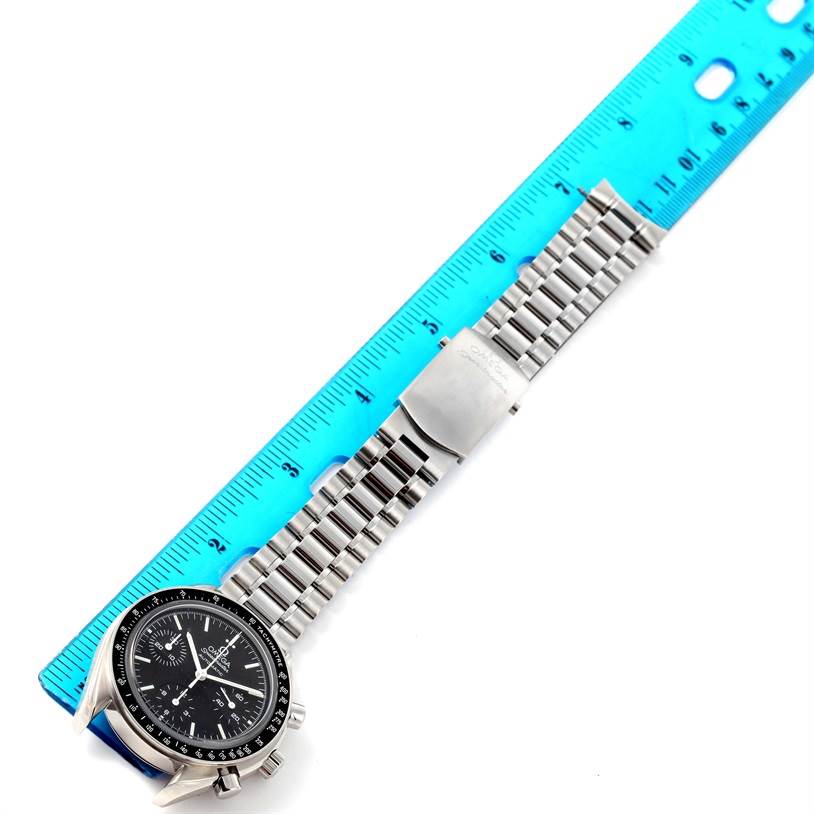 The image shows an Omega Speedmaster 3539.50.00 Men
s Stainless Steel Black Dial 3539.50.00 Men
s Stainless Steel Black Dial watch laid flat with a blue ruler measuring its length.