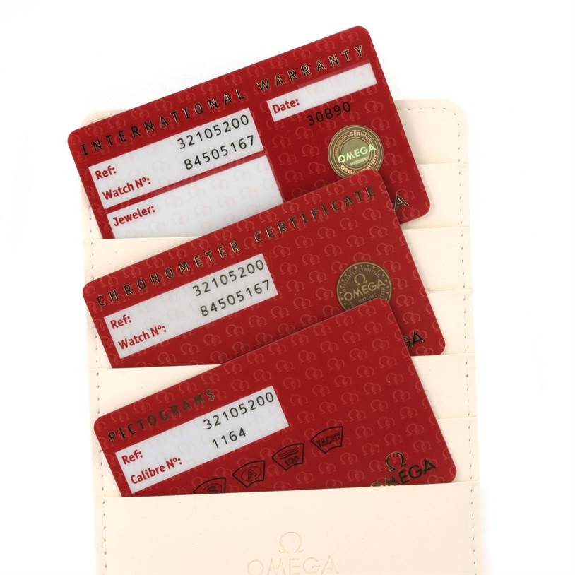 The image shows international warranty, chronometer certificate, and pictogram cards for an Omega Speedmaster 3210.52.00 Men
s Stainless Steel Black Dial 3210.52.00 Men
s Stainless Steel Black Dial watch.