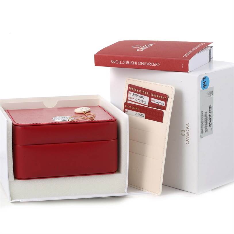 The image shows the packaging, warranty card, and operating instructions for an Omega Speedmaster 3570.50.00 Men
s Stainless Steel Black Dial 3570.50.00 Men
s Stainless Steel Black Dial watch from an angle highlighting the box contents.