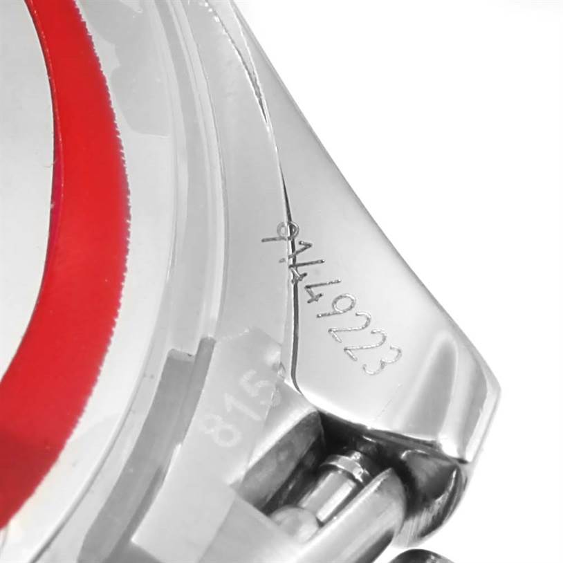 The image shows a close-up of an Omega Speedmaster 3539.50.00 Men
s Stainless Steel Black Dial 3539.50.00 Men
s Stainless Steel Black Dial watch
s lug and part of the bezel, displaying engraved serial numbers.