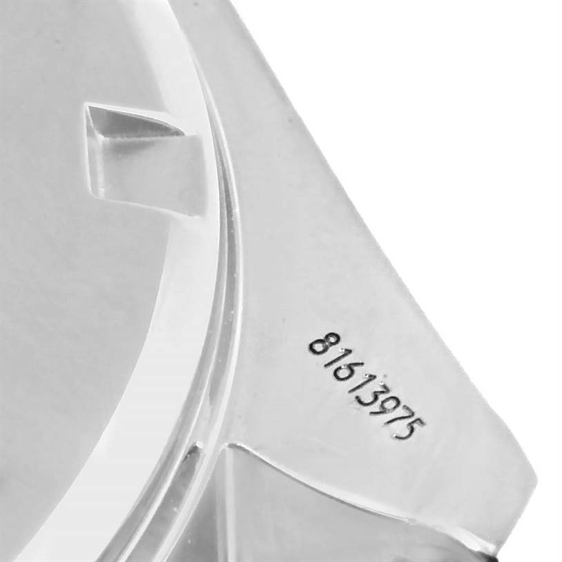 This image shows the rear side view of the case back of an Omega Speedmaster 3222.80.00 Men
s Stainless Steel Blue Dial 3222.80.00 Men
s Stainless Steel Blue Dial watch with a visible part of the serial number.