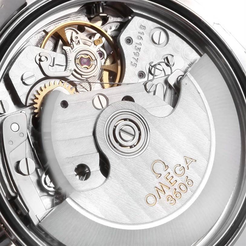 The image shows the intricate workings of the Omega Speedmaster 3222.80.00 Men
s Stainless Steel Blue Dial 3222.80.00 Men
s Stainless Steel Blue Dial
s movement, including gears and the rotor, viewed from the back.