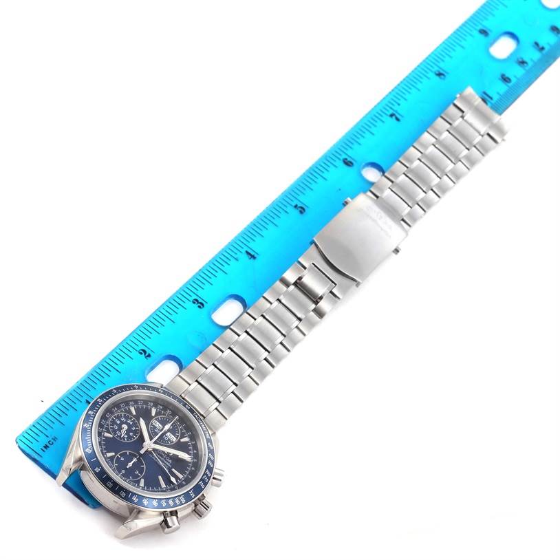 The image shows an Omega Speedmaster 3222.80.00 Men
s Stainless Steel Blue Dial 3222.80.00 Men
s Stainless Steel Blue Dial watch laid flat next to a ruler, displaying the watch face, bracelet, and clasp.