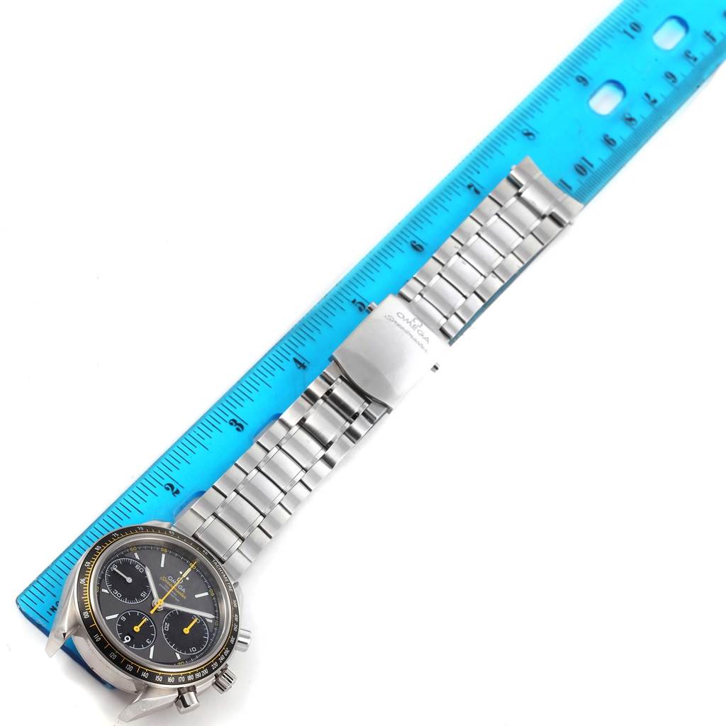 The image shows an Omega Speedmaster 326.30.40.50.06.001 Men
s Stainless Steel Grey Dial 326.30.40.50.06.001 Men
s Stainless Steel Grey Dial watch laid flat next to a blue ruler, highlighting the metal bracelet and clasp.