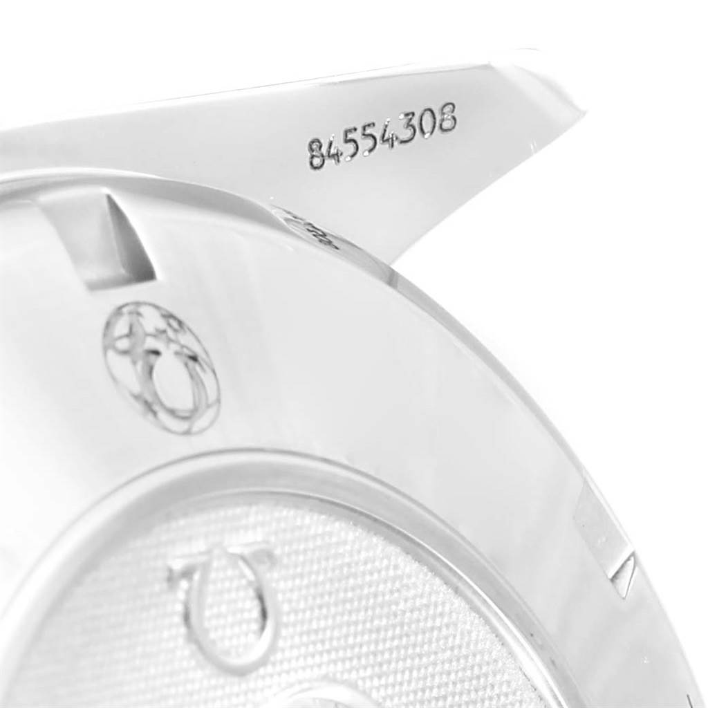 This close-up image shows the serial number and part of the case back of an Omega Speedmaster 3212.80.00 Men
s Stainless Steel Blue Dial 3212.80.00 Men
s Stainless Steel Blue Dial watch.