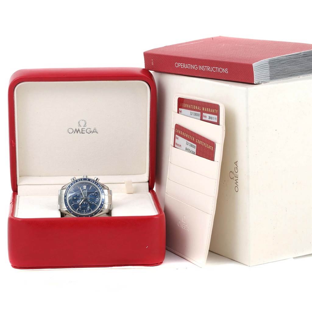 The Omega Speedmaster 3212.80.00 Men
s Stainless Steel Blue Dial 3212.80.00 Men
s Stainless Steel Blue Dial watch is shown front-facing in its box, with warranty cards, a certificate, and an operating manual.
