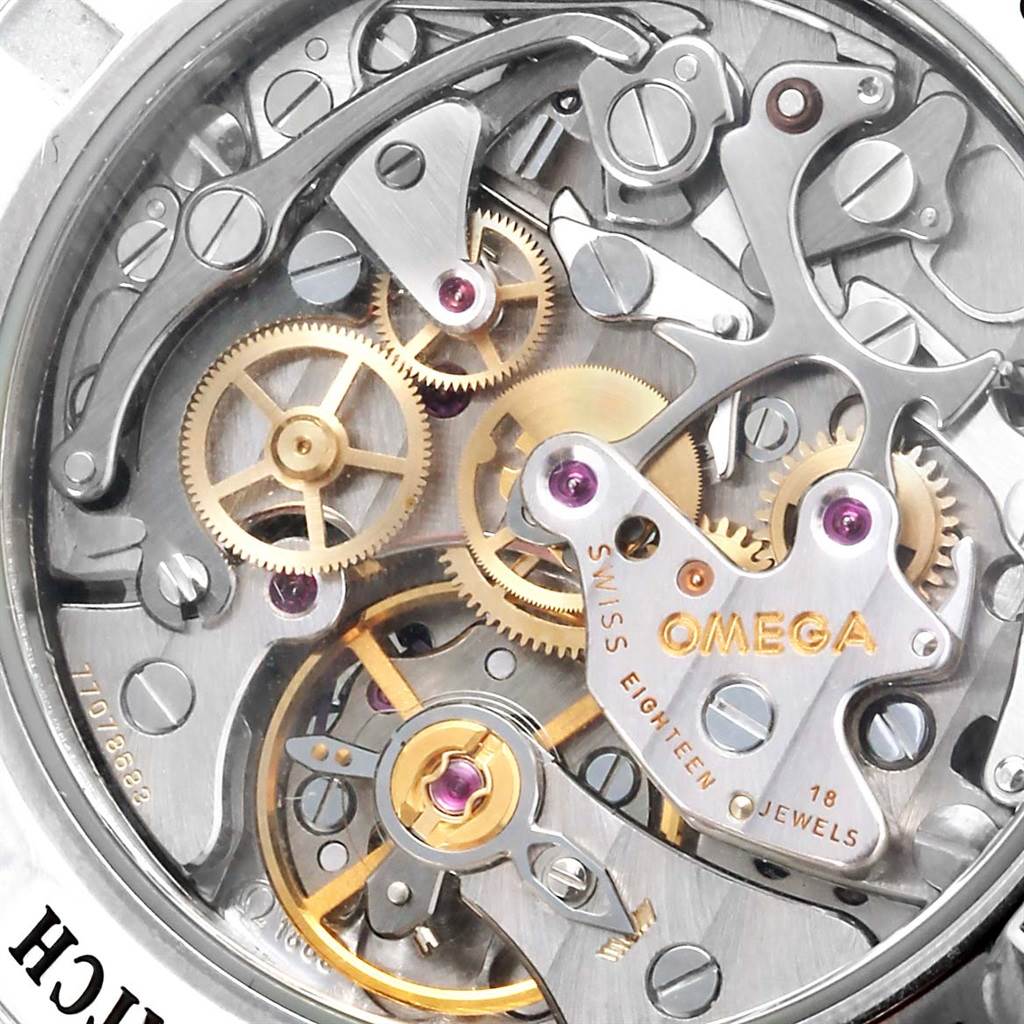 The image shows a close-up of the mechanical movement of an Omega Speedmaster 3573.50.00 Men
s Stainless Steel Black Dial 3573.50.00 Men
s Stainless Steel Black Dial watch, highlighting its intricate gears and components.