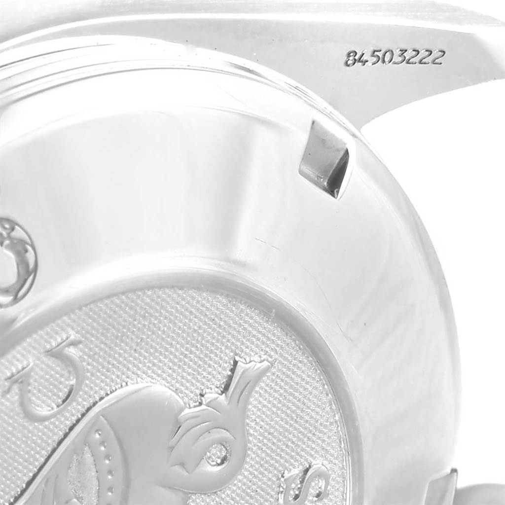 The image shows a close-up of the case back with engraved details and part of the lug of an Omega Speedmaster 3210.52.00 Men
s Stainless Steel Black Dial 3210.52.00 Men
s Stainless Steel Black Dial watch.