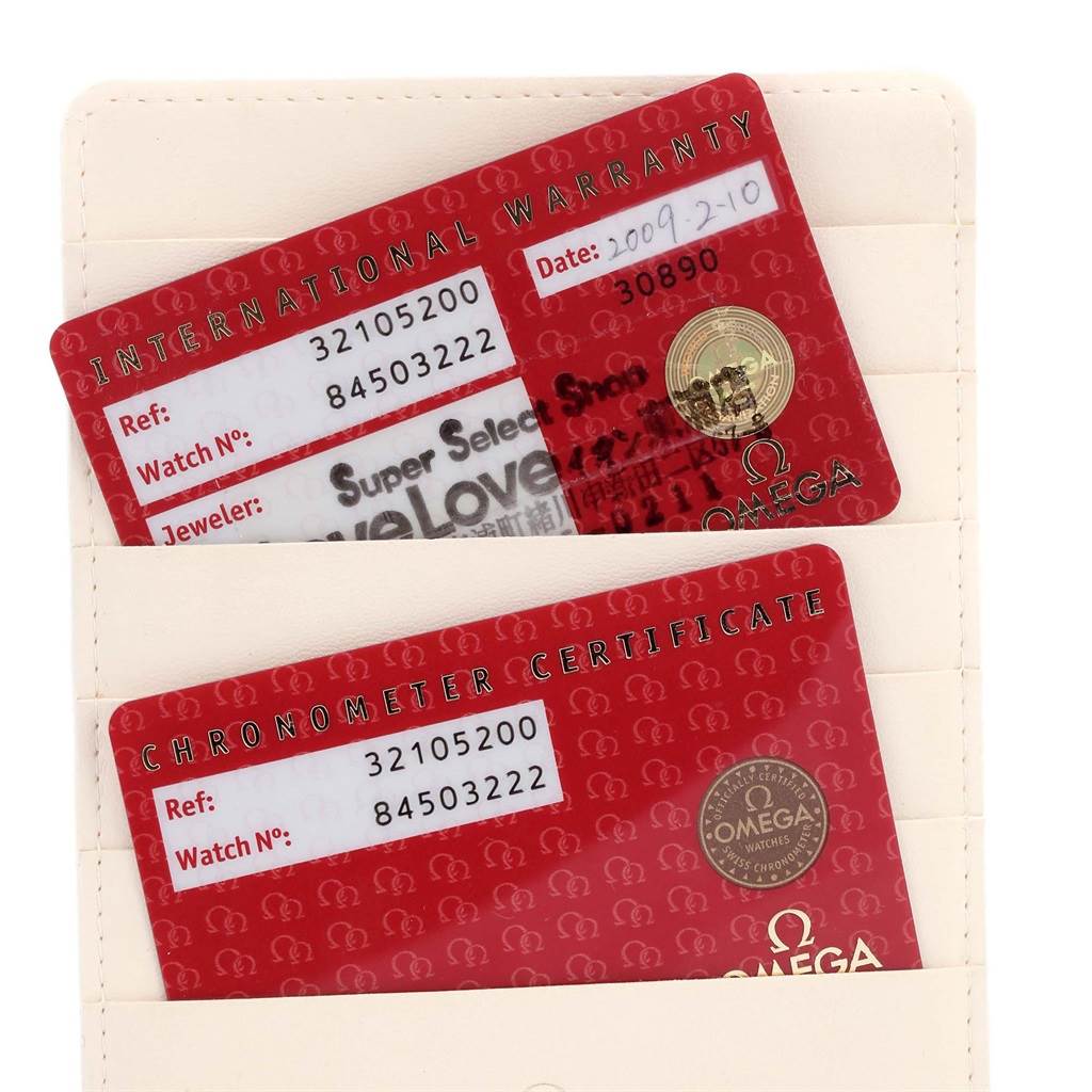 The image shows the International Warranty and Chronometer Certificate cards for an Omega Speedmaster 3210.52.00 Men
s Stainless Steel Black Dial 3210.52.00 Men
s Stainless Steel Black Dial watch.