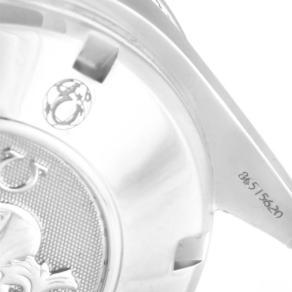 The image shows the back case of an Omega Speedmaster 3211.31.00 Men
s Stainless Steel Silver Dial 3211.31.00 Men
s Stainless Steel Silver Dial watch, highlighting the logo and serial number.