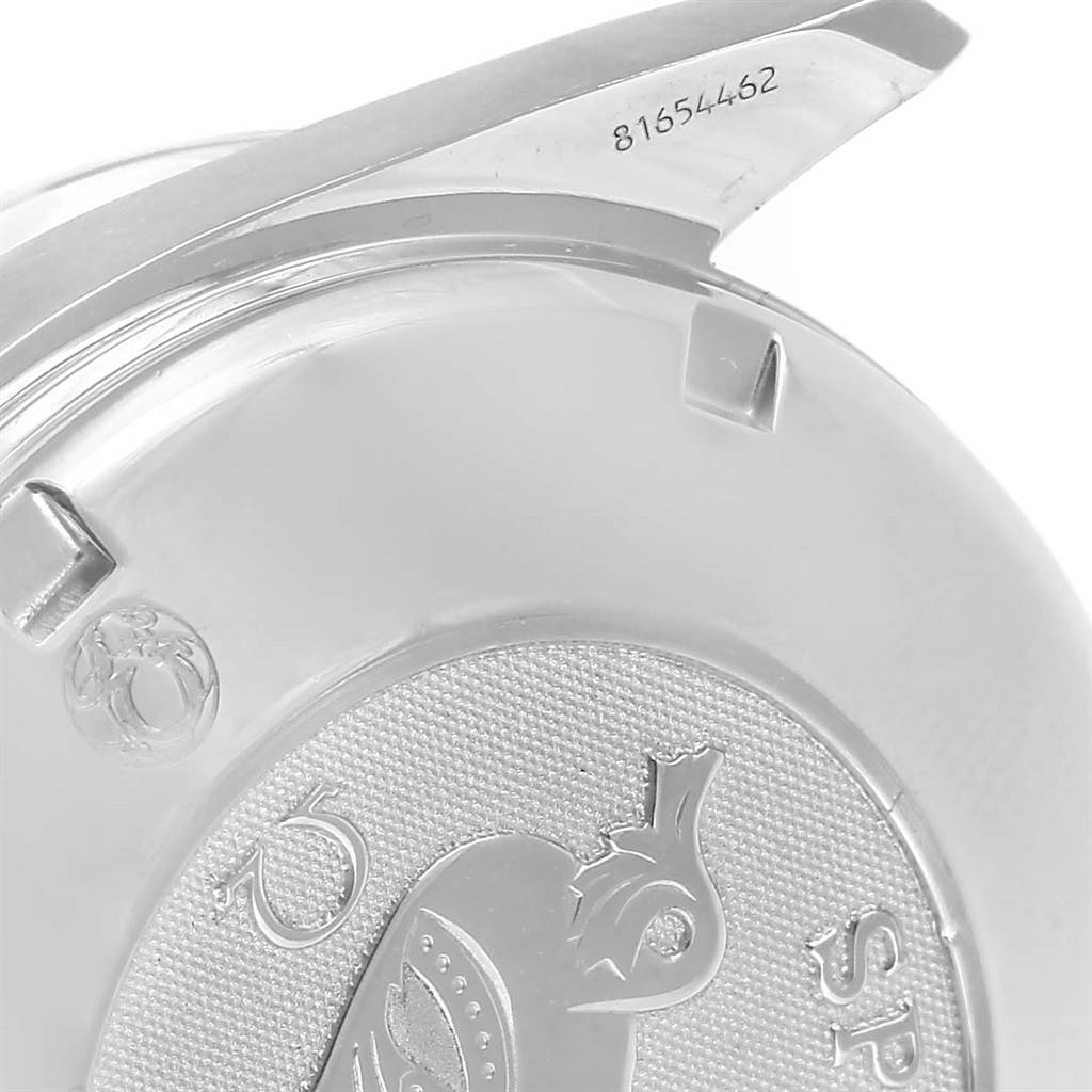 The image shows the backside and part of the clasp of an Omega Speedmaster 3210.52.00 Men
s Stainless Steel Black Dial 3210.52.00 Men
s Stainless Steel Black Dial watch, highlighting the serial number and etched design.