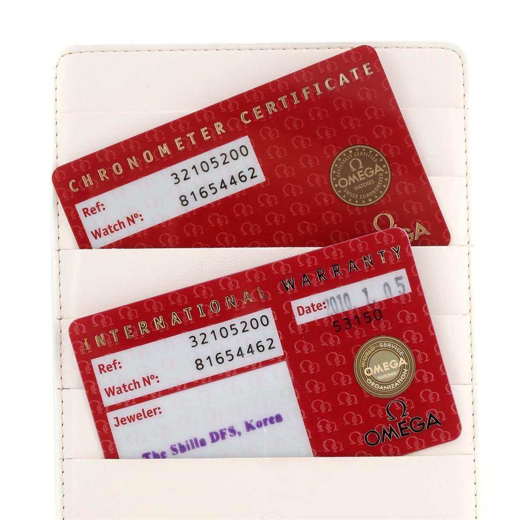 The image shows Omega Speedmaster 3210.52.00 Men
s Stainless Steel Black Dial 3210.52.00 Men
s Stainless Steel Black Dial
s chronometer certificate and international warranty cards in a holder.