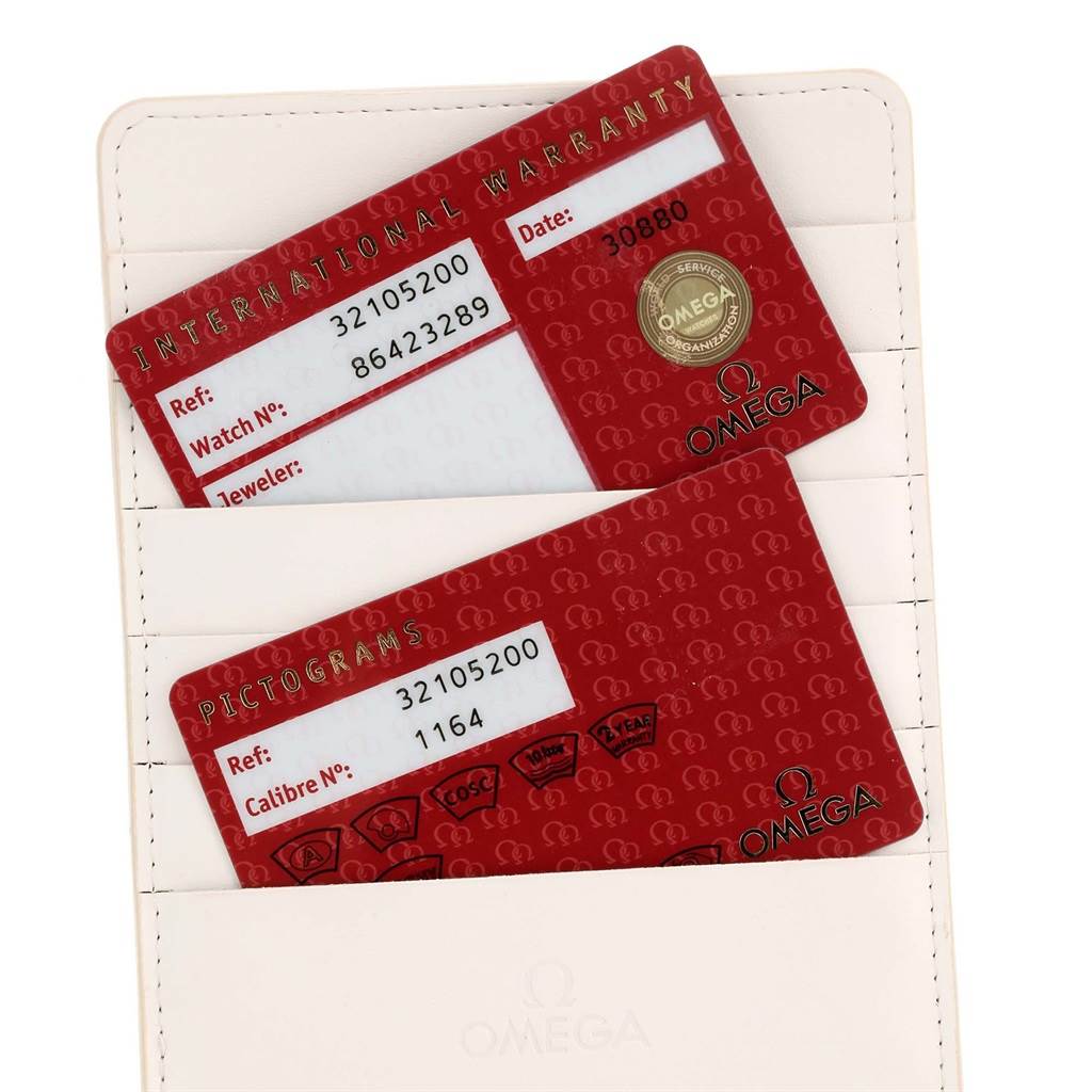 The image shows international warranty and pictograms cards for the Omega Speedmaster 3210.52.00 Men
s Stainless Steel Black Dial 3210.52.00 Men
s Stainless Steel Black Dial model, positioned inside a cardholder.