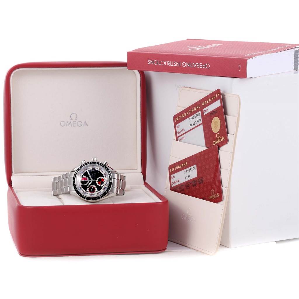 The Omega Speedmaster 3210.52.00 Men
s Stainless Steel Black Dial 3210.52.00 Men
s Stainless Steel Black Dial watch is shown in its box with warranty cards and an instruction manual beside it.