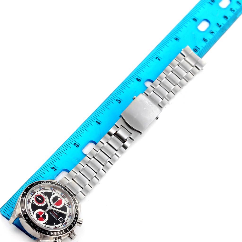 The image shows an Omega Speedmaster 3210.52.00 Men
s Stainless Steel Black Dial 3210.52.00 Men
s Stainless Steel Black Dial watch laid flat with its bracelet aligned next to a blue ruler for scale.