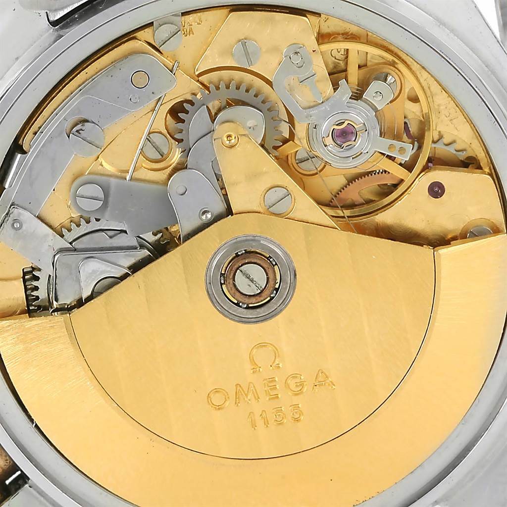 A close-up view of the Omega Speedmaster 3716.50.00 Men
s Steel and Gold (two tone) Black Dial 3716.50.00 Men
s Steel and Gold (two tone) Black Dial
s movement, displaying the intricate gears and components with the Omega logo.