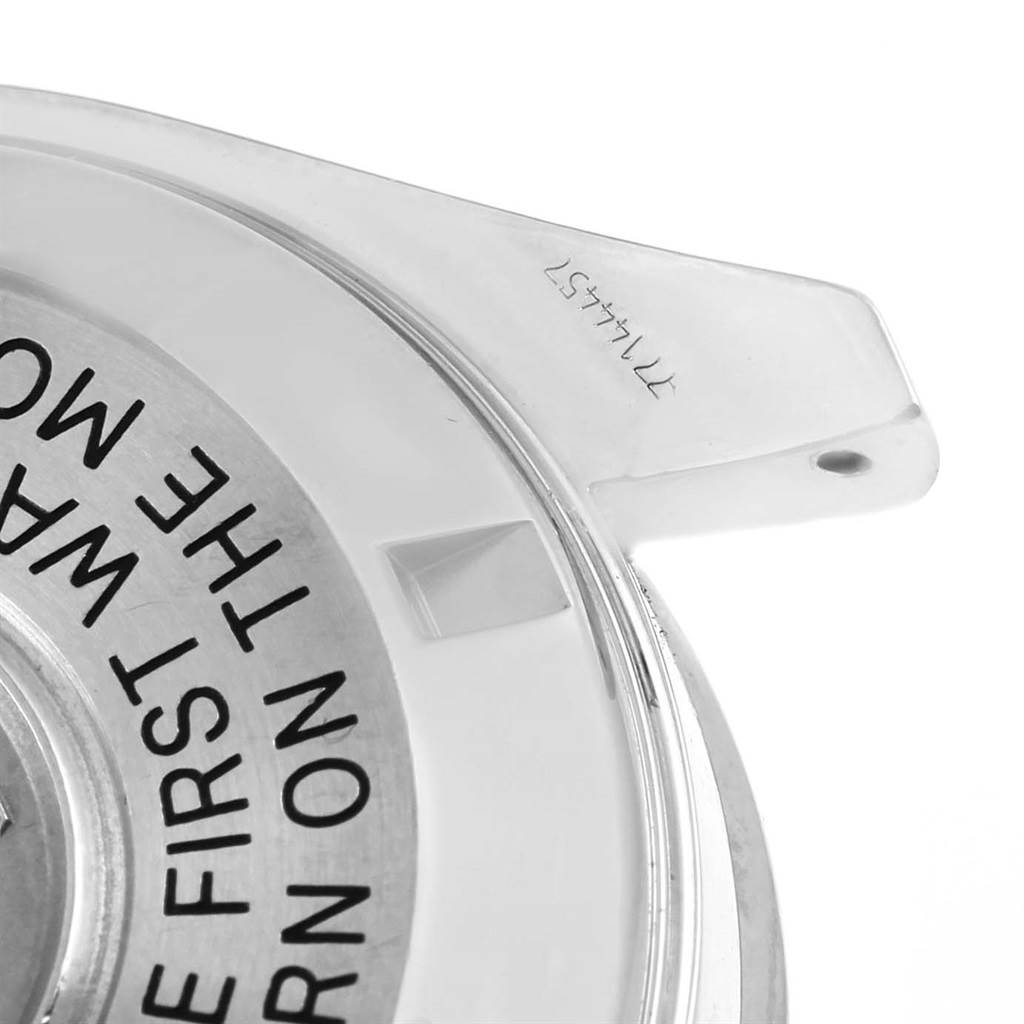 The image shows a close-up angle of the Omega Speedmaster 3570.50.00 Men
s Stainless Steel Black Dial 3570.50.00 Men
s Stainless Steel Black Dial watch’s protective case, highlighting the backside with engraved text.