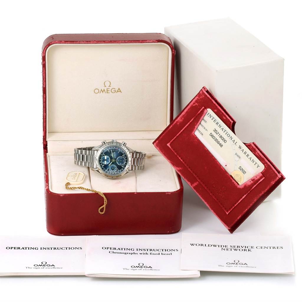 The image shows an Omega Speedmaster 3521.80.00 Men
s Stainless Steel Blue Dial 3521.80.00 Men
s Stainless Steel Blue Dial watch in its box, with operating instructions, warranty card, and service centers booklet.