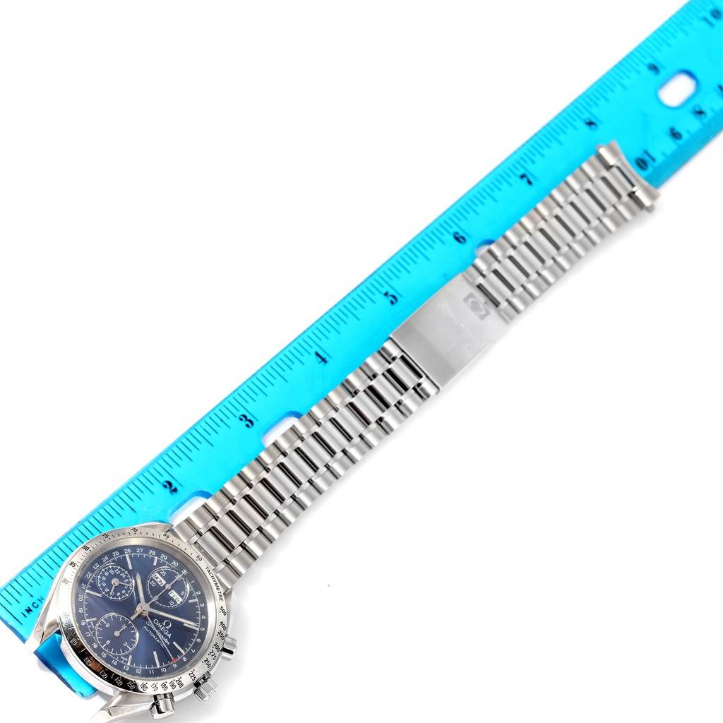 This image shows the Omega Speedmaster 3521.80.00 Men
s Stainless Steel Blue Dial 3521.80.00 Men
s Stainless Steel Blue Dial watch face and bracelet with a ruler measuring the bracelet length.