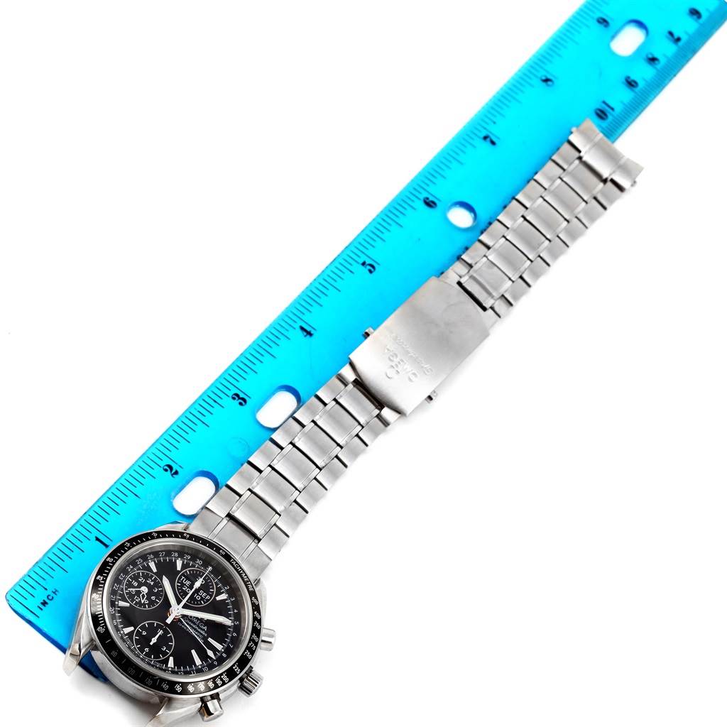The image shows an Omega Speedmaster 3220.50.00 Men
s Stainless Steel Black Dial 3220.50.00 Men
s Stainless Steel Black Dial watch lying flat with its stainless steel bracelet and clasp next to a blue ruler.