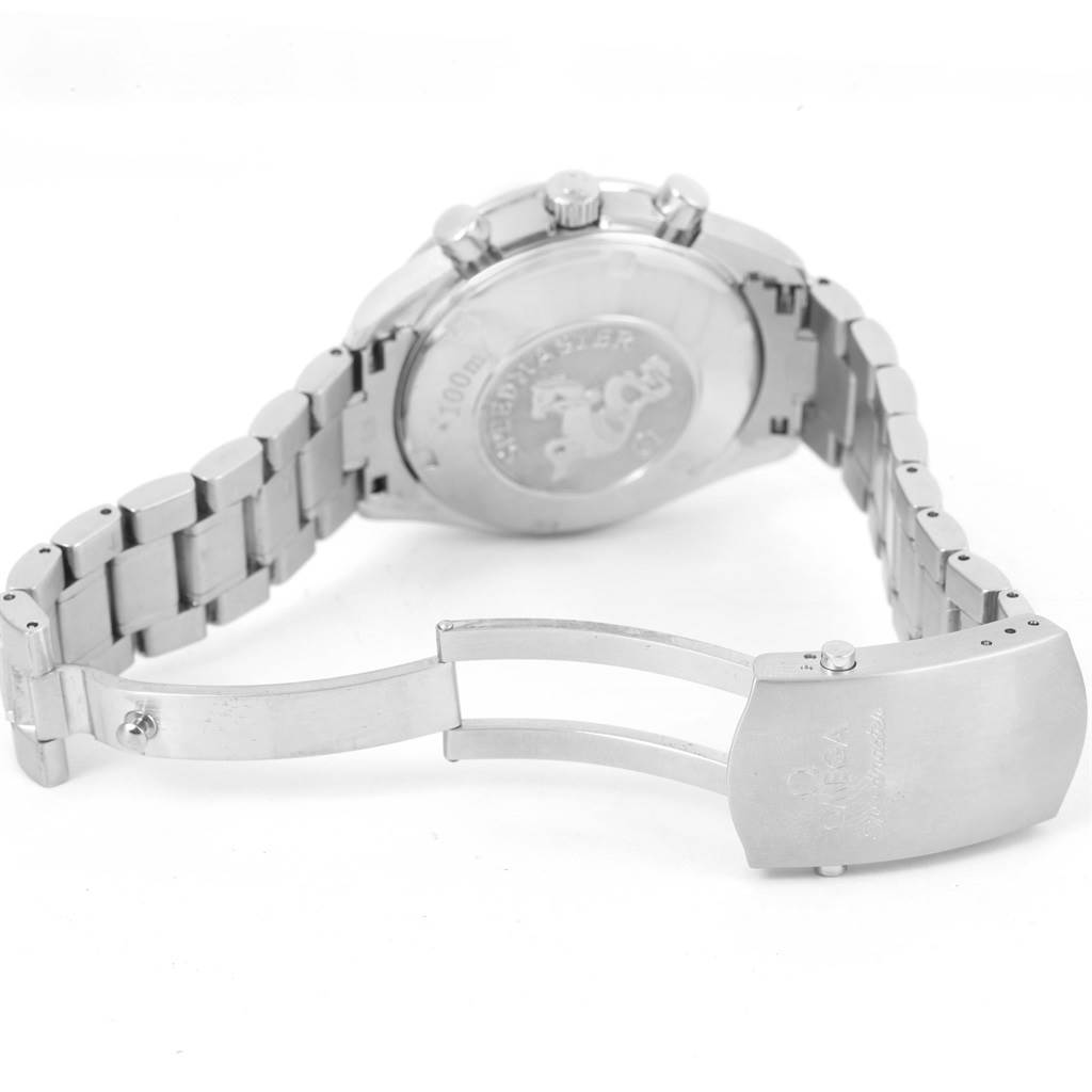 The image shows the back of an Omega Speedmaster 3220.50.00 Men
s Stainless Steel Black Dial 3220.50.00 Men
s Stainless Steel Black Dial watch and its bracelet clasp, which is partially open.