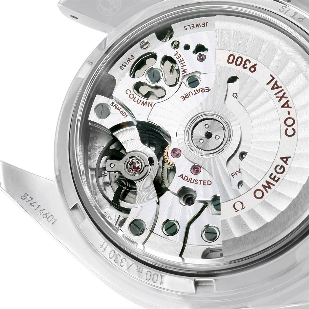 The image shows an angled view of the open back of an Omega Speedmaster 311.30.44.51.01.002 Men
s Stainless Steel Black Dial 311.30.44.51.01.002 Men
s Stainless Steel Black Dial, revealing its intricate movement and inner mechanics.