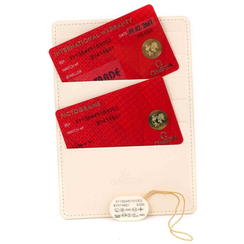 The image shows two Omega Speedmaster 311.30.44.51.01.002 Men
s Stainless Steel Black Dial 311.30.44.51.01.002 Men
s Stainless Steel Black Dial warranty cards and a hang tag on a light-colored cardholder.