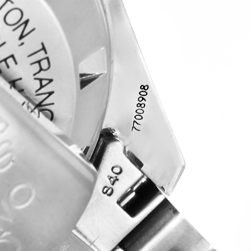 The image shows a close-up view of the Omega Speedmaster 3560.50.00 Men
s Stainless Steel Black Dial 3560.50.00 Men
s Stainless Steel Black Dial
s case back and part of the metal bracelet with some engravings.