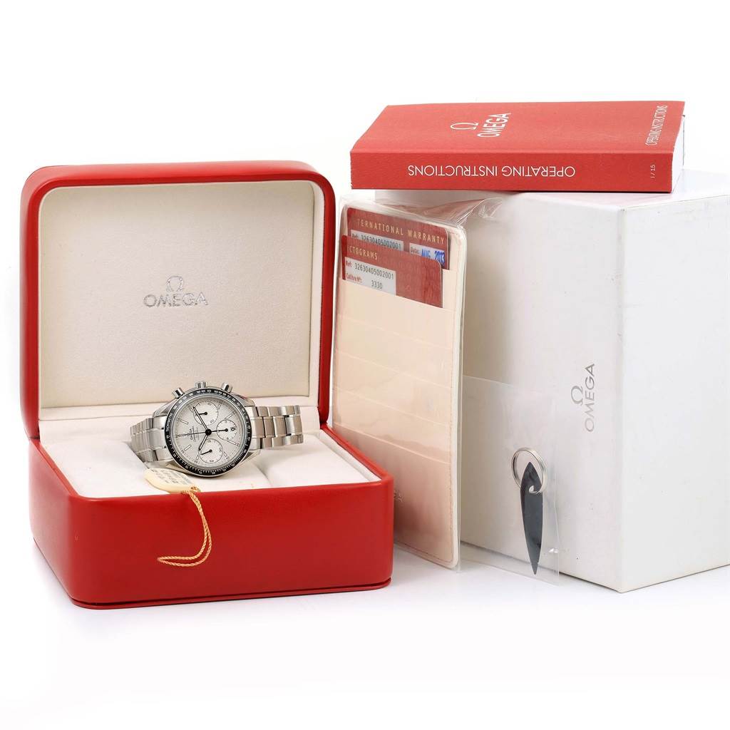 The Omega Speedmaster 326.30.40.50.02.001 Men
s Stainless Steel White Dial 326.30.40.50.02.001 Men
s Stainless Steel White Dial watch is displayed in its red box along with the warranty card and operating instructions.