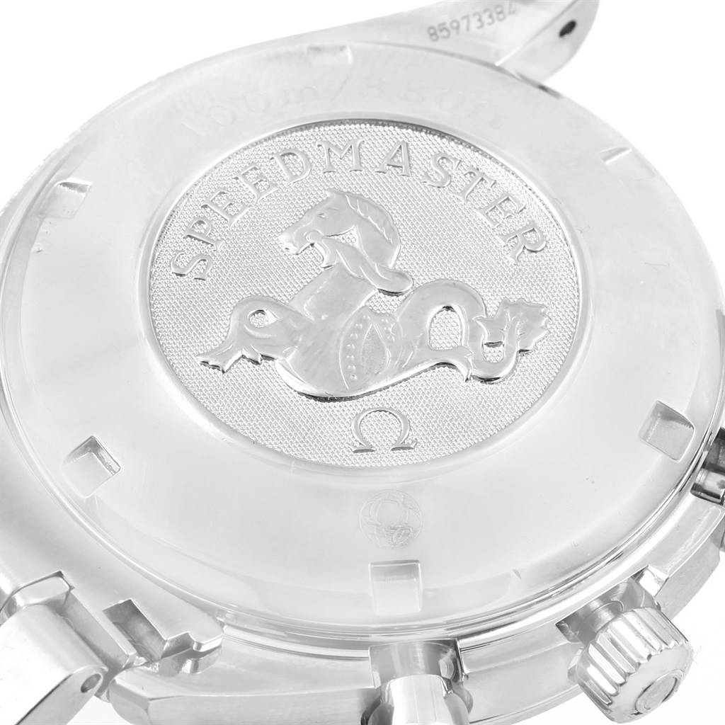 This image shows the back of an Omega Speedmaster 3210.52.00 Men
s Stainless Steel Black Dial 3210.52.00 Men
s Stainless Steel Black Dial watch, highlighting its engraved emblem and part of the bracelet and crown.