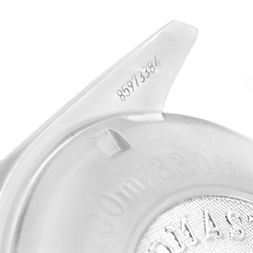 The image shows a close-up of the underside of an Omega Speedmaster 3210.52.00 Men
s Stainless Steel Black Dial 3210.52.00 Men
s Stainless Steel Black Dial watch, displaying depth rating and part of the watch back.