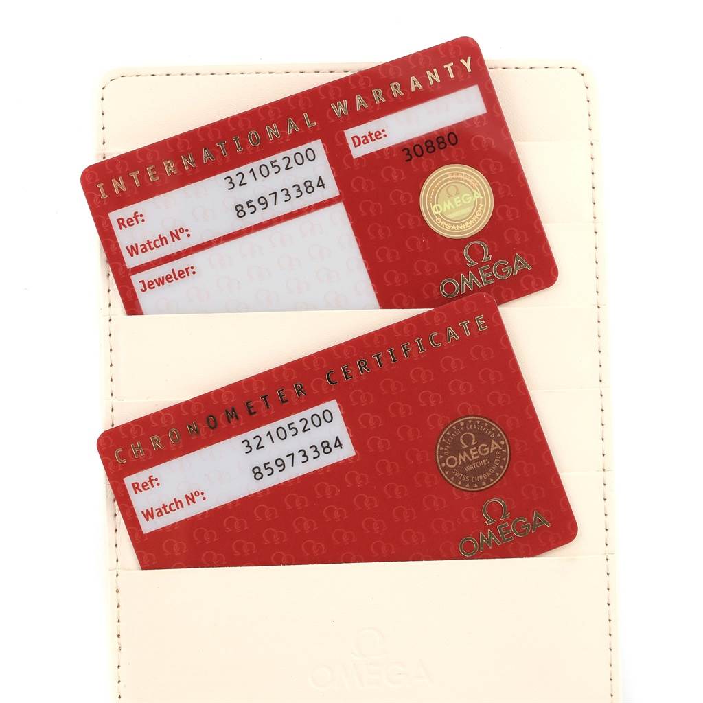 The image shows the international warranty and chronometer certificate cards for an Omega Speedmaster 3210.52.00 Men
s Stainless Steel Black Dial 3210.52.00 Men
s Stainless Steel Black Dial watch.