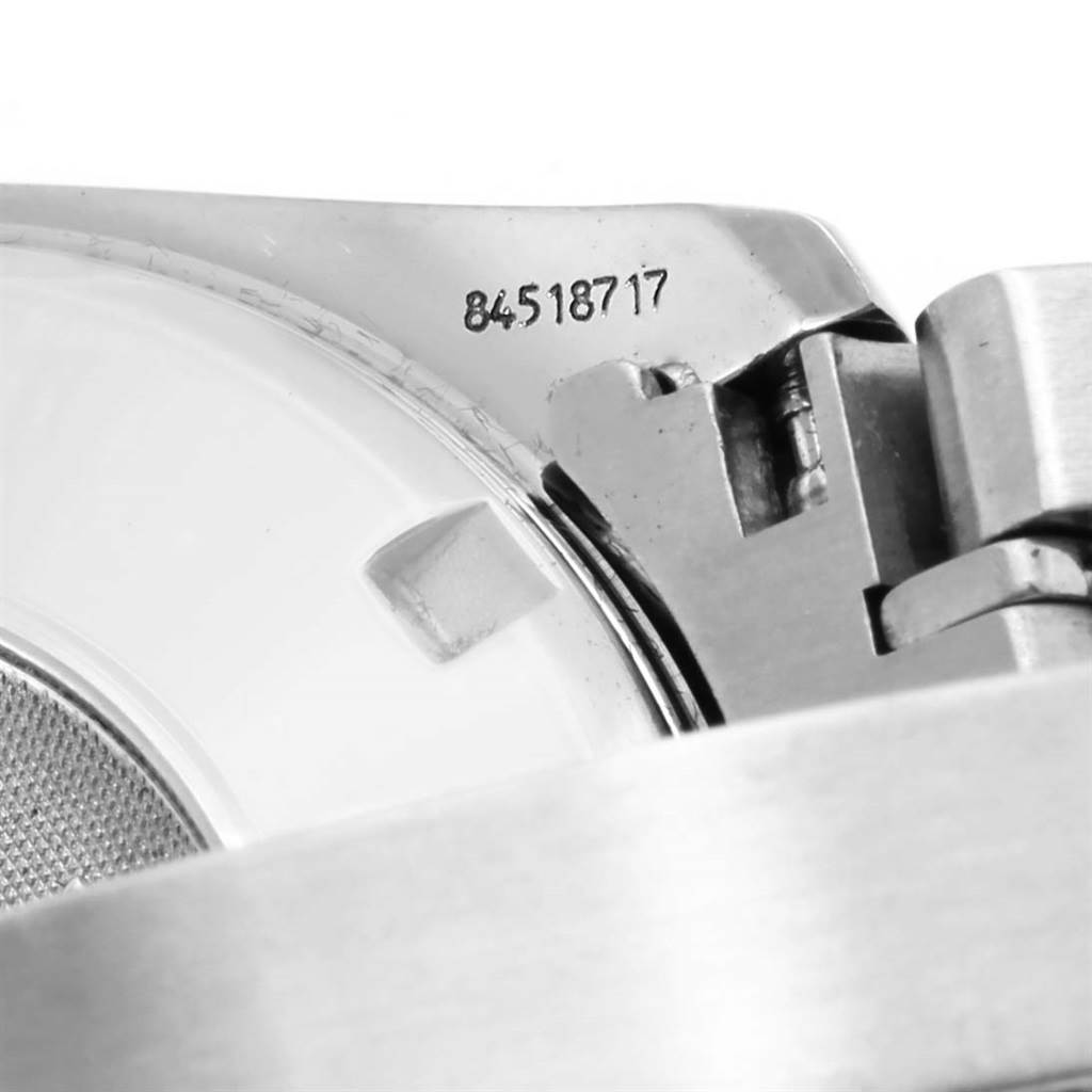 Close-up shot of the Omega Speedmaster 3210.50.00 Men
s Stainless Steel Black Dial 3210.50.00 Men
s Stainless Steel Black Dial casing back and serial number, showing bracelet attachment and hinge mechanism.