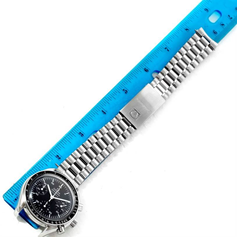 The image shows an Omega Speedmaster 3510.50.00 Men
s Stainless Steel Black Dial 3510.50.00 Men
s Stainless Steel Black Dial watch lying flat, displaying its face and stainless steel bracelet alongside a ruler for scale.