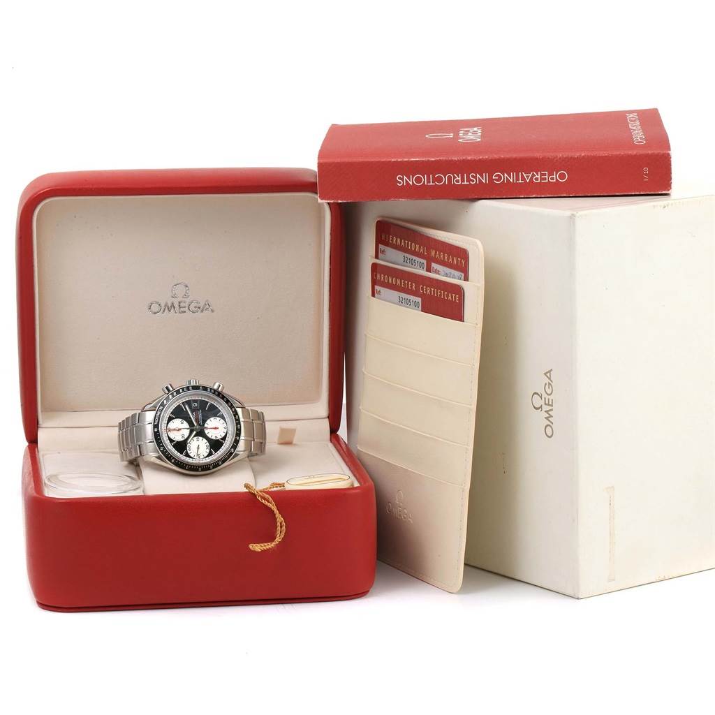 The Omega Speedmaster 3210.51.00 Men
s Stainless Steel Black Dial 3210.51.00 Men
s Stainless Steel Black Dial watch is shown front-facing in its red box, alongside operating instructions and warranty cards.