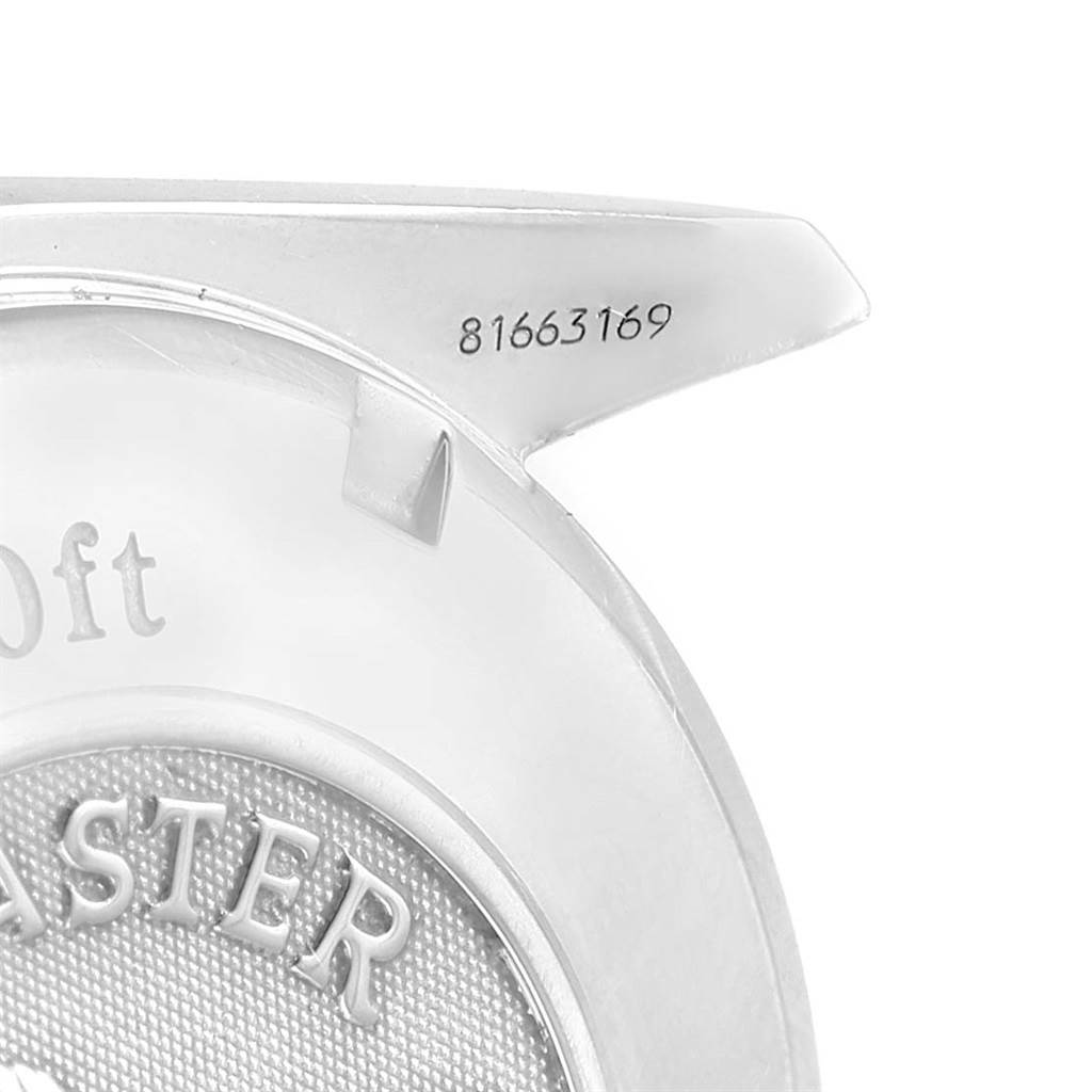 This is a close-up of the case back of an Omega Speedmaster 3210.51.00 Men
s Stainless Steel Black Dial 3210.51.00 Men
s Stainless Steel Black Dial watch, showing part of the "Speedmaster" engraving and a serial number.