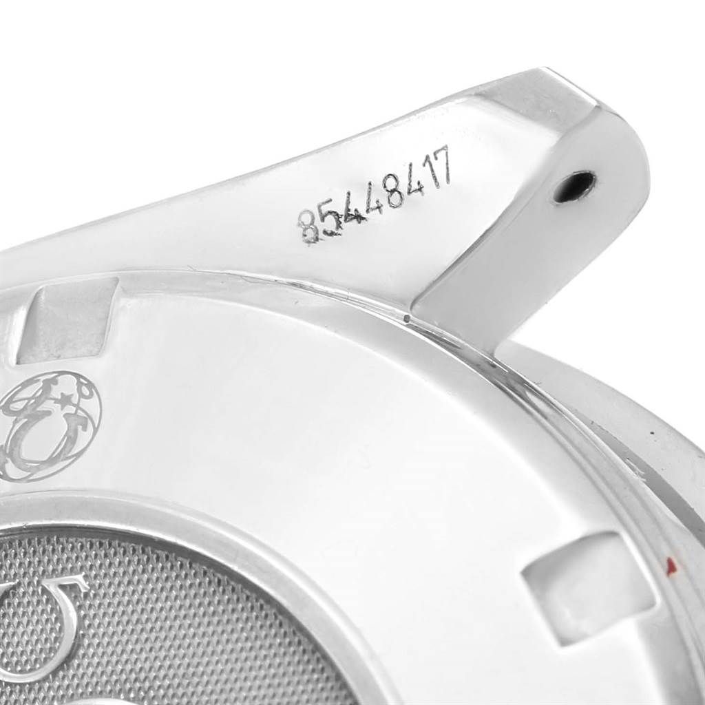 The image shows a close-up of the Omega Speedmaster 3210.52.00 Men
s Stainless Steel Black Dial 3210.52.00 Men
s Stainless Steel Black Dial
s rear casing and one of its lugs, displaying its serial number.