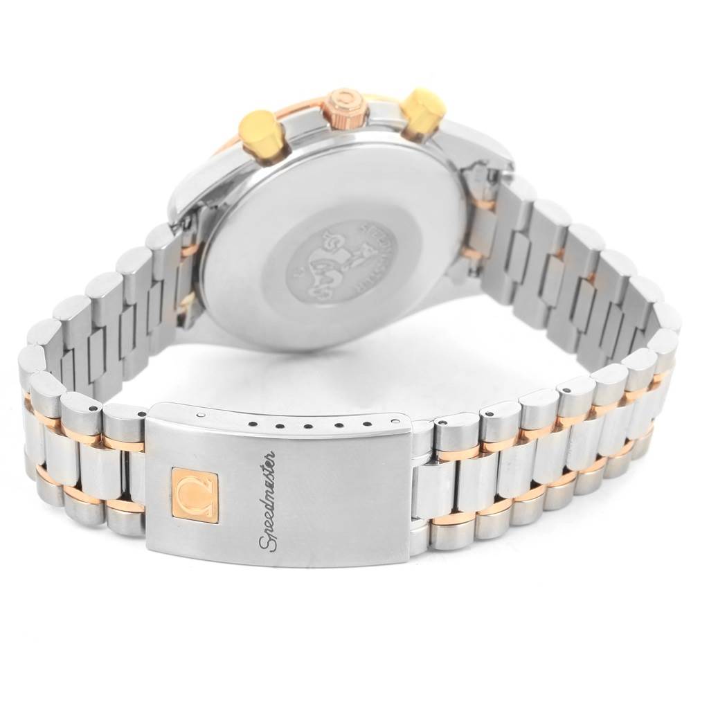 The image shows the back of an Omega Speedmaster 3716.50.00 Men
s Steel and Gold (two tone) Black Dial 3716.50.00 Men
s Steel and Gold (two tone) Black Dial watch, highlighting its clasp, bracelet, and case back.