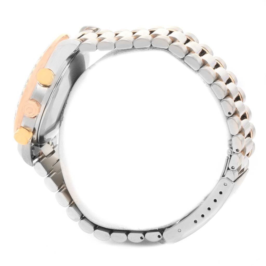 The image shows a side view of an Omega Speedmaster 3716.50.00 Men
s Steel and Gold (two tone) Black Dial 3716.50.00 Men
s Steel and Gold (two tone) Black Dial watch, highlighting its buttons and metal bracelet.